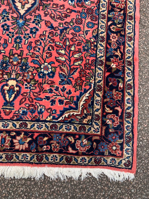 A Persian pink ground wool rug ~ 155cm x 105cm