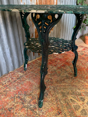 A green garden table and chairs set
