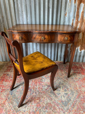 A serpentine desk and leather chair by Bevan Funnell