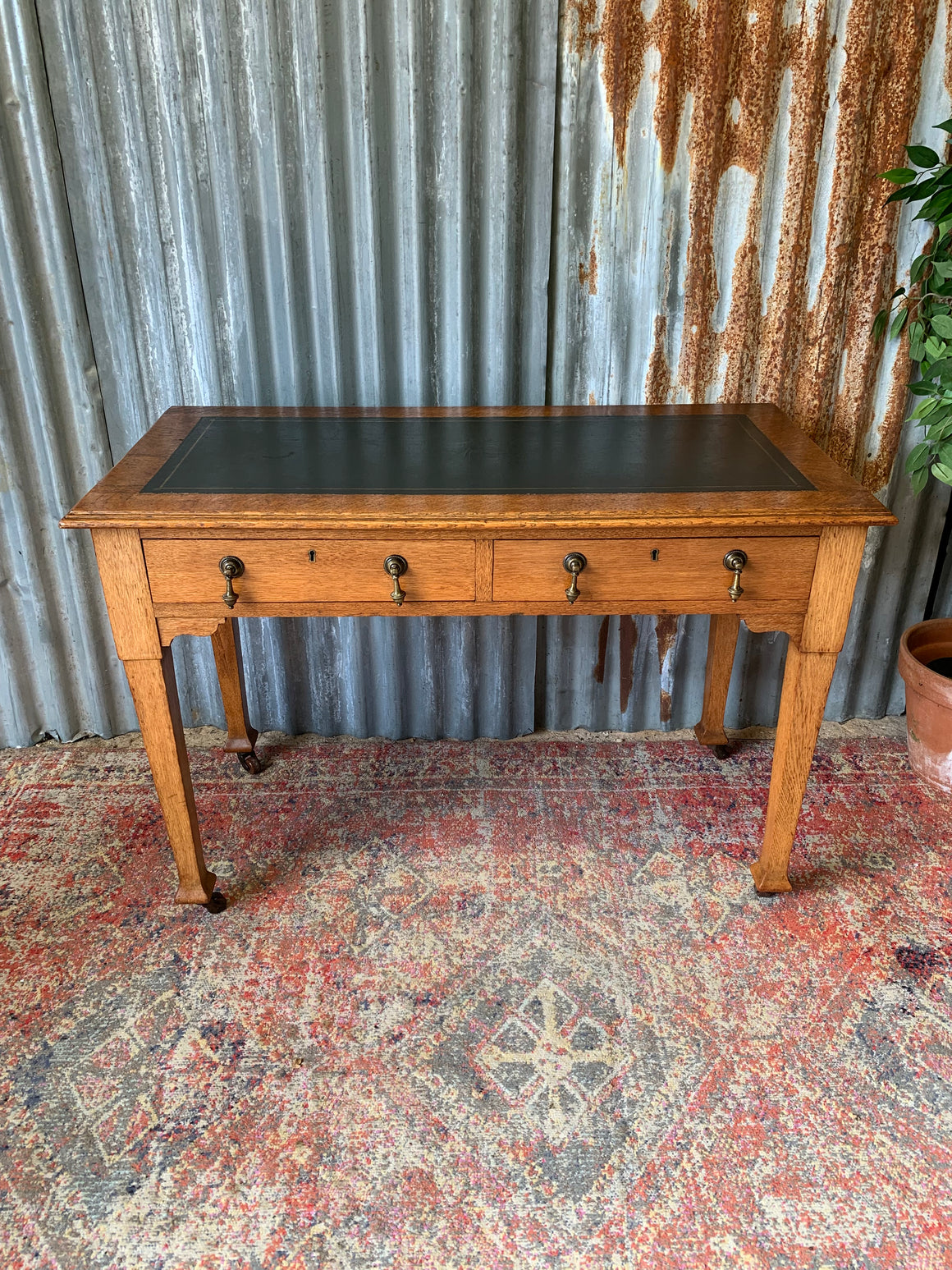 A blonde wood desk on castors