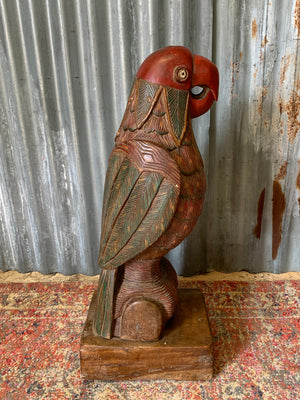 A very large carved wooden polychrome parrot statue