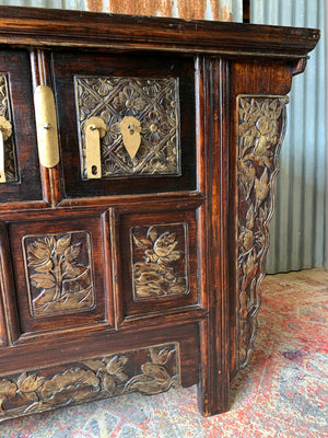 A carved wooden Chinese altar cabinet