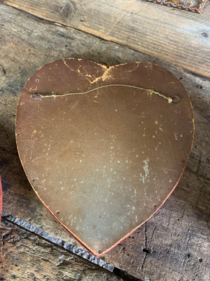 A pair of Victorian porcelain heart plaques on red velvet mounts