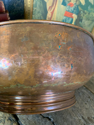 A large English beaten copper bowl