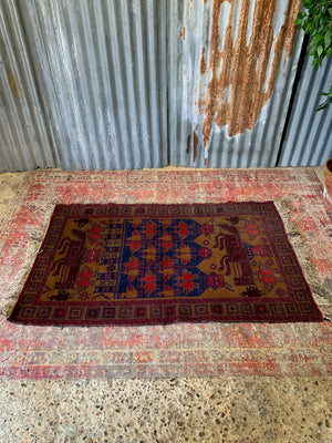 A Persian or Kurdish red ground pictorial rug - 165cm x 92cm