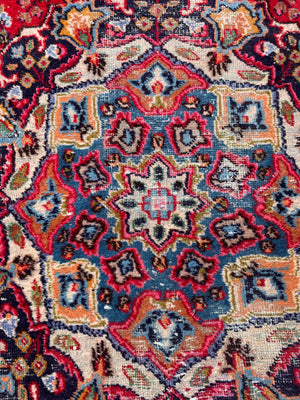 A large red ground Persian rug - 299cm x 194cm