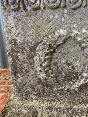 A cast stone cornucopia on plinth