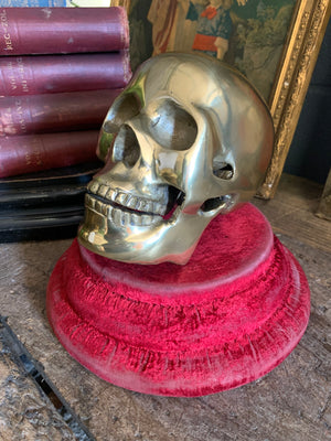 A life-size brass human skull model