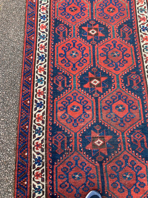 A long red ground blue Persian runner rug ~ 304cm x 104cm