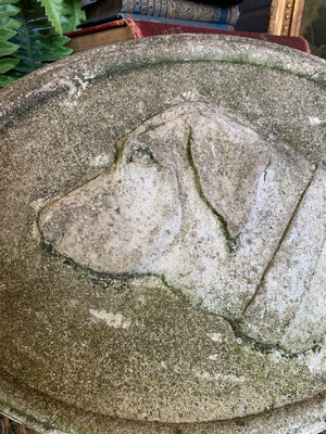 An oval cast stone plaque depicting a dog's head in profile ~B