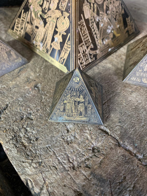 A group of four etched brass Egyptian revival pyramids