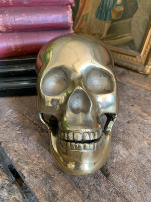 A life-size brass human skull model