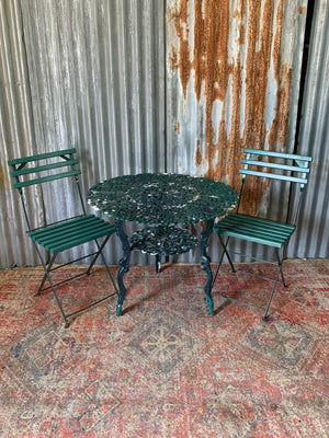A green garden table and chairs set