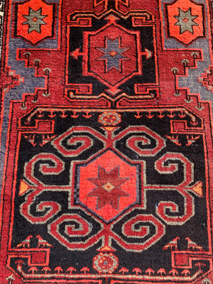 A Turkish red ground rug ~ 211cm x 138cm