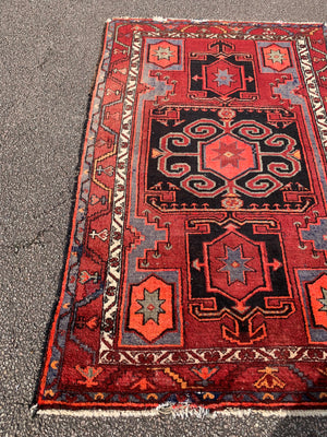 A Turkish red ground rug ~ 211cm x 138cm