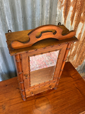 A small French faux bamboo mirrored cabinet