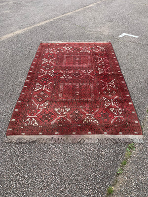 A very large rectangular red ground Persian rug - 264cm x 159cm
