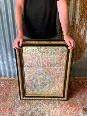 A large French black and gold mirror