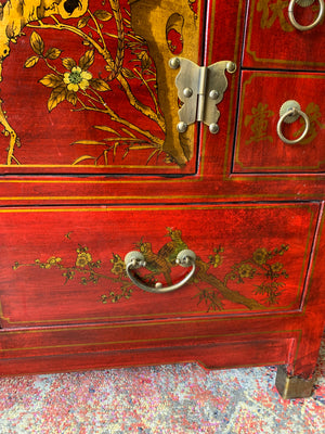 A red and gold lacquered chinoiserie cabinet