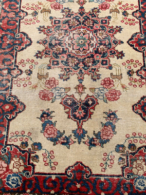 A Persian cream ground rug ~ 194cm x 133cm