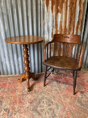 An oak spindle back captain's chair