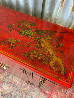 A red and gold lacquered chinoiserie cabinet