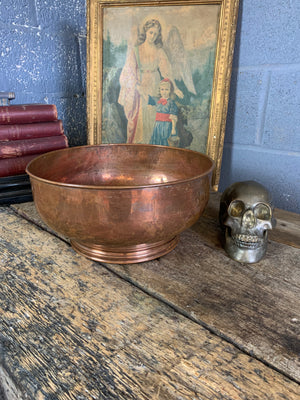 A large English beaten copper bowl