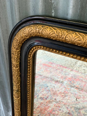 A large French black and gold mirror