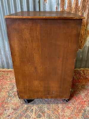 A pine chest of six drawers on castors