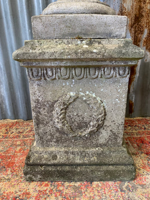 A cast stone cornucopia on plinth