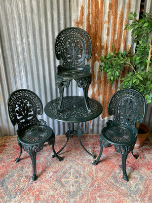 A green garden table and chairs set