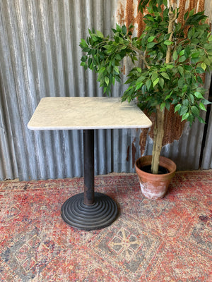A cast iron garden table with heavy marble top ~ A