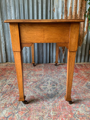 A blonde wood desk on castors