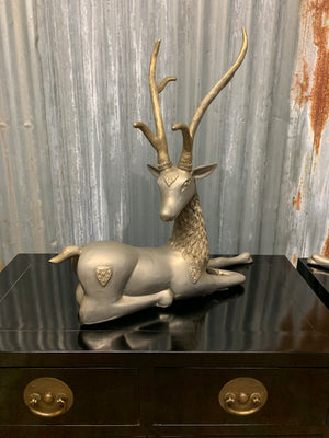 A pair of opposing white metal stags