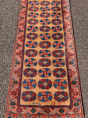 A long yellow ground red blue Persian runner rug ~ 257cm x 67cm