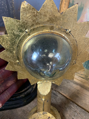 A gilt refraction candlestick with sunburst detail