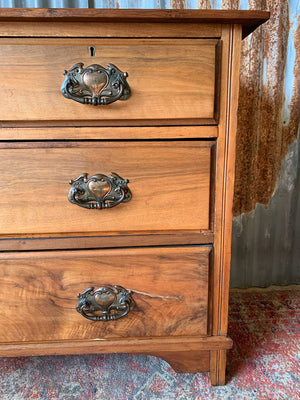 An Art Nouveau chest of drawers