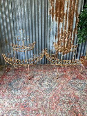 A pair of white wirework demi-lune plant stands