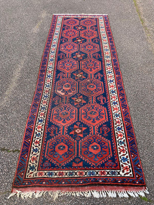 A long red ground blue Persian runner rug ~ 304cm x 104cm