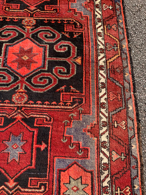 A Turkish red ground rug ~ 211cm x 138cm