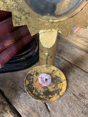 A gilt refraction candlestick with sunburst detail