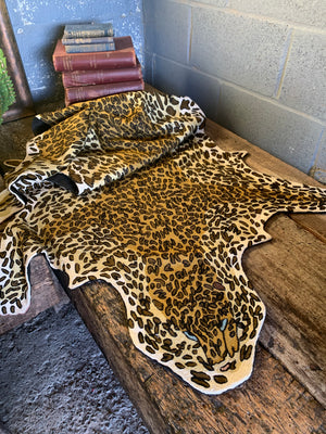 A Liberty of London faux leopard skin rug