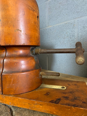 A wooden millinery hat stretcher