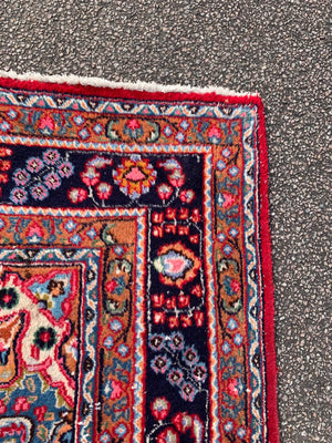 A large red ground Persian rug - 299cm x 194cm