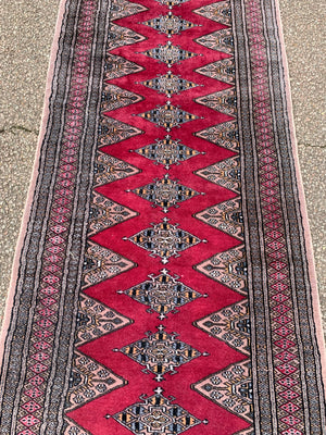 A long pink ground Persian runner rug ~ 318cm x 83cm