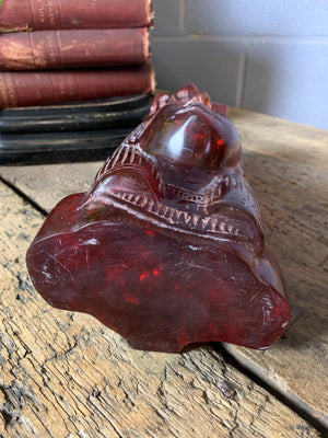 A carved bust of Tutankhamen in red Faturan