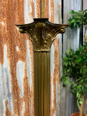 A brass Corinthian column standard lamp on lion paw feet