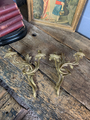 A pair of heavy brass Rococo style candle scones