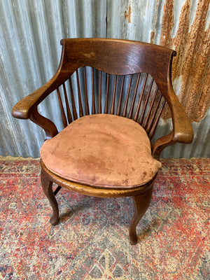 A banker's chair with caned seat