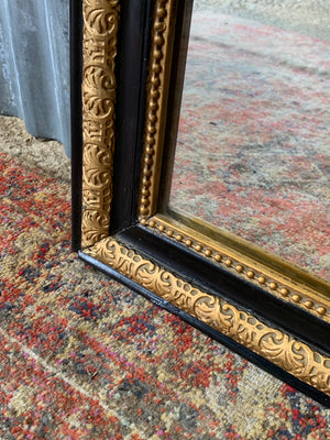 A large French black and gold mirror